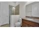 Bathroom featuring granite countertop, tile shower, and glass door at 11741 Savona Way, Orlando, FL 32827