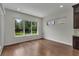 Bright bonus room featuring hardwood floors and large windows overlooking the backyard at 11741 Savona Way, Orlando, FL 32827