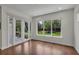 Bright bonus room featuring hardwood floors and large windows leading to the outdoor patio area at 11741 Savona Way, Orlando, FL 32827