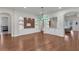 Dining space featuring hardwood floors, custom built-in storage, and an elegant green chandelier at 11741 Savona Way, Orlando, FL 32827