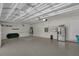 Spacious three-car garage featuring white walls, overhead lighting, and ample storage space at 11741 Savona Way, Orlando, FL 32827