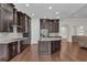 Gourmet kitchen with an island, granite countertops, and stainless steel appliances at 11741 Savona Way, Orlando, FL 32827