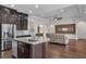View from kitchen into open-concept living room featuring hardwood floors and modern finishes at 11741 Savona Way, Orlando, FL 32827