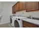 Laundry room showcasing modern washer and dryer units at 11741 Savona Way, Orlando, FL 32827