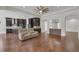 Open-concept living room and kitchen area with hardwood floors, and a built in kitchen bar at 11741 Savona Way, Orlando, FL 32827