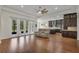 Open floor plan showcasing the living room with hardwood floors flowing into the gourmet kitchen at 11741 Savona Way, Orlando, FL 32827
