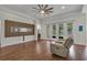 Spacious living room with hardwood floors, large windows, and a decorative wood accent wall for media at 11741 Savona Way, Orlando, FL 32827