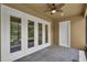 Covered patio featuring brick flooring and access to a screened-in lanai and backyard at 11741 Savona Way, Orlando, FL 32827