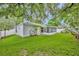 The private backyard features lush green lawn, an enclosed porch, and a white vinyl fence at 1181 Welch Hill Cir, Apopka, FL 32712