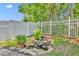 Landscaped backyard with a charming stone lined pond and a white picket fence at 1181 Welch Hill Cir, Apopka, FL 32712