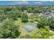 Aerial view of the community basketball court surrounded by mature trees and landscaping at 1181 Welch Hill Cir, Apopka, FL 32712