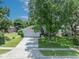 Charming single Gathering home boasts mature trees, lush green grass, and a meticulously maintained lawn at 1181 Welch Hill Cir, Apopka, FL 32712