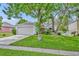 Charming single-story home featuring a well-manicured lawn and a two-car garage in a quiet neighborhood at 1181 Welch Hill Cir, Apopka, FL 32712