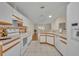 Open kitchen featuring white cabinets and appliances, tile floors and views to the Gathering room at 1181 Welch Hill Cir, Apopka, FL 32712