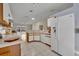 Bright kitchen featuring white appliances and cabinets, tile floors and an open floorplan at 1181 Welch Hill Cir, Apopka, FL 32712