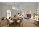 Stylized open concept living and dining area with fireplace and modern furnishings at 1181 Welch Hill Cir, Apopka, FL 32712