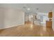 Spacious living room with laminate wood flooring and access to kitchen and entryway creating a flowing space at 1181 Welch Hill Cir, Apopka, FL 32712