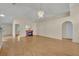 Light-filled living area has laminate flooring, high ceilings, an electric fireplace and access to other rooms at 1181 Welch Hill Cir, Apopka, FL 32712
