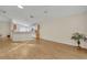 Open living space with a partial view of the kitchen, featuring laminate flooring and neutral wall colors at 1181 Welch Hill Cir, Apopka, FL 32712
