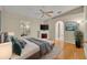 Spacious bedroom with wood floors, fireplace, ceiling fan, and en-suite bathroom at 1181 Welch Hill Cir, Apopka, FL 32712