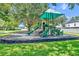 Neighborhood playground with green turf, slide, and climbing structure at 1181 Welch Hill Cir, Apopka, FL 32712