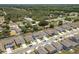Aerial view of a residential neighborhood featuring well-maintained homes and tree-lined streets at 1209 Deepwater Cir, Eagle Lake, FL 33839