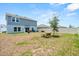 Wide backyard view of the home with a bench and patio with seating at 1209 Deepwater Cir, Eagle Lake, FL 33839