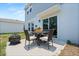 Backyard patio with chairs, fire pit, and flower decorations at 1209 Deepwater Cir, Eagle Lake, FL 33839