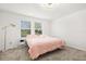 Bright bedroom with two windows and neutral tones, creating a calming and inviting space at 1209 Deepwater Cir, Eagle Lake, FL 33839