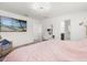 Bright bedroom with a TV, vanity, and ensuite bathroom, providing the comforts you need at 1209 Deepwater Cir, Eagle Lake, FL 33839