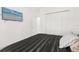 A cozy bedroom features a mounted television and closet with plenty of storage space at 1209 Deepwater Cir, Eagle Lake, FL 33839