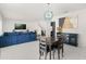Open-concept dining area featuring tile floors, a modern chandelier, and comfortable seating at 1209 Deepwater Cir, Eagle Lake, FL 33839
