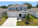 Beautiful two-story home with a covered porch, manicured landscaping, and a two-car garage at 1209 Deepwater Cir, Eagle Lake, FL 33839