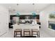 Modern kitchen with a center island, stainless steel appliances, and stylish pendant lighting at 1209 Deepwater Cir, Eagle Lake, FL 33839