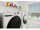 Well lit laundry room featuring a Samsung washer and dryer at 1209 Deepwater Cir, Eagle Lake, FL 33839