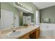 This bathroom features double sinks, a large mirror, a garden tub, and a shower with a glass door at 1245 Reagans Reserve Blvd, Apopka, FL 32712