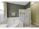 This bathroom features a garden tub, a shower with a glass door, and neutral paint at 1245 Reagans Reserve Blvd, Apopka, FL 32712