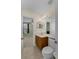 Bathroom featuring vanity with wood cabinets and a view into the bedroom space with bright window at 1245 Reagans Reserve Blvd, Apopka, FL 32712