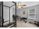 Bedroom featuring home gym equipment, a ceiling fan, and a bright window allowing natural light at 1245 Reagans Reserve Blvd, Apopka, FL 32712