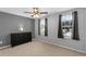 This bedroom features neutral paint, carpeted floors, two windows, and a large dresser at 1245 Reagans Reserve Blvd, Apopka, FL 32712