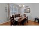Bright dining room featuring a wooden table with seating for six, a window, and modern decor at 1245 Reagans Reserve Blvd, Apopka, FL 32712