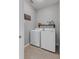 Laundry room featuring a white front load washer and dryer set with shelving above at 1245 Reagans Reserve Blvd, Apopka, FL 32712