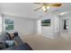 This loft features a ceiling fan, carpeted floors, neutral paint, and a mounted television at 1245 Reagans Reserve Blvd, Apopka, FL 32712