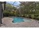 Backyard pool featuring a screened-in enclosure with brick pavers and green landscape surrounding at 1245 Reagans Reserve Blvd, Apopka, FL 32712