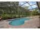 Inviting screened-in pool with brick pavers and surrounding landscape, with outdoor furniture at 1245 Reagans Reserve Blvd, Apopka, FL 32712
