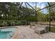Backyard pool with screened-in enclosure, brick pavers, and outdoor seating arrangements at 1245 Reagans Reserve Blvd, Apopka, FL 32712