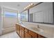 Bathroom featuring a double vanity, bathtub, and shower at 12824 Cloverdale Ln, Clermont, FL 34711