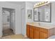 Bathroom view showcasing a vanity sink and doorway leading to the Primary bedroom at 12824 Cloverdale Ln, Clermont, FL 34711