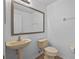 Powder room with a pedestal sink and toilet at 12824 Cloverdale Ln, Clermont, FL 34711