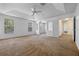 Spacious bonus room featuring multiple windows, carpet, and a ceiling fan at 12824 Cloverdale Ln, Clermont, FL 34711
